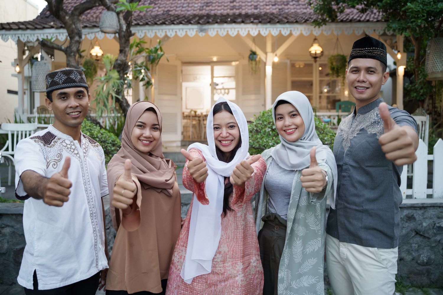 A group of Muslim people giving thumbs up