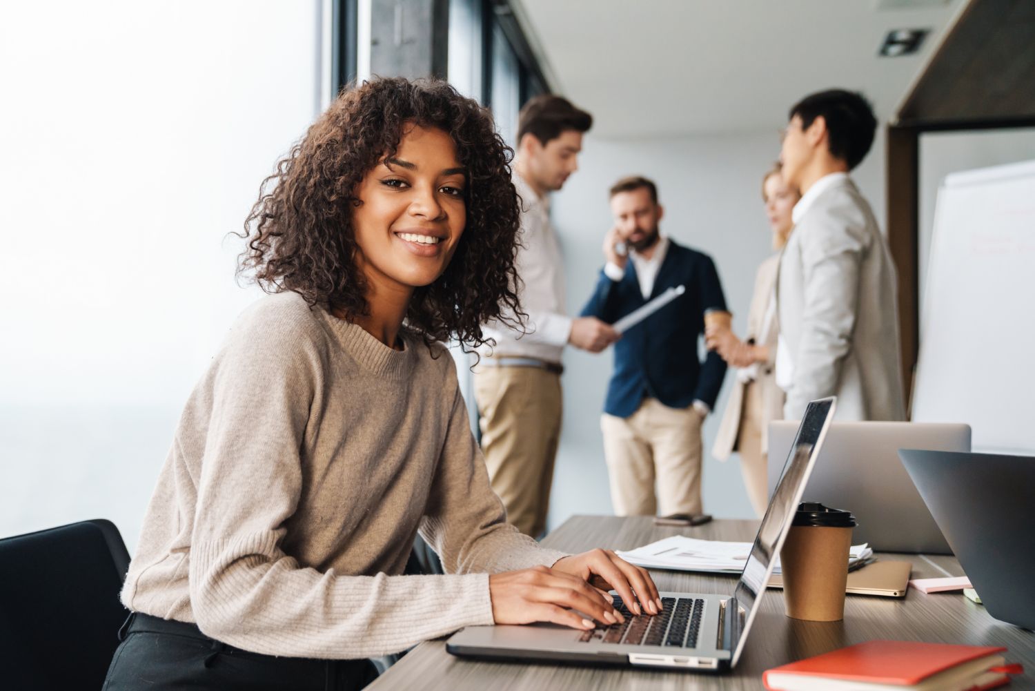 Woman working at laptop smiling